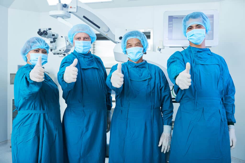 Cheerful surgeons showing thumbs up 468868