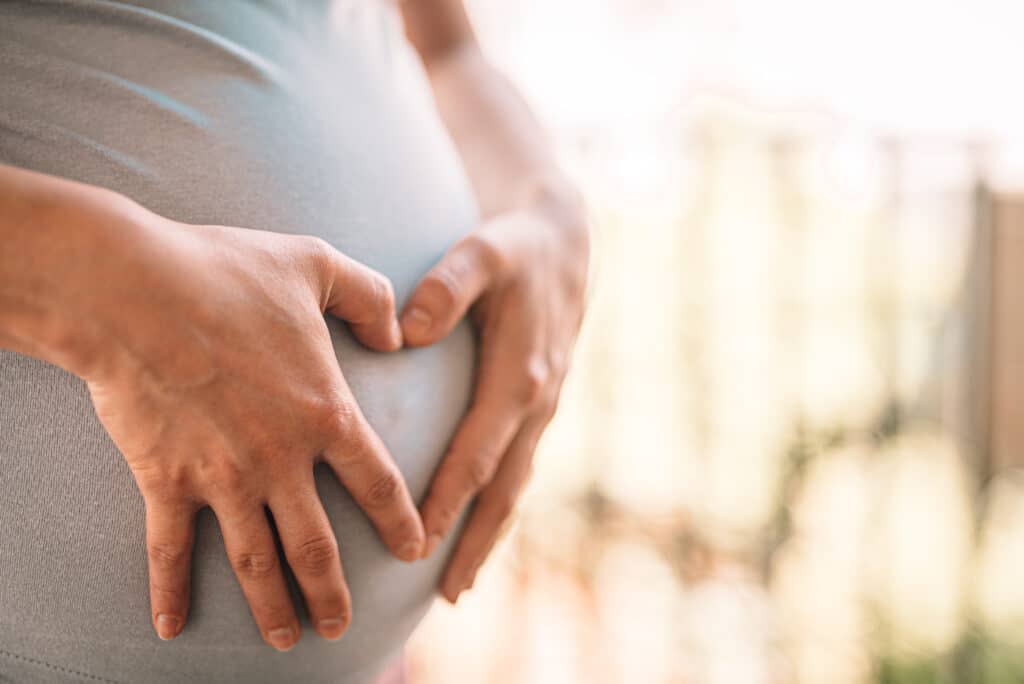 pregnant woman makes heart on her tummy picjumbo com